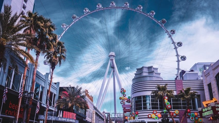 High Roller Ferris Wheel High Roller observation wheel towering above the Las Vegas Strip with palm-lined promenade below